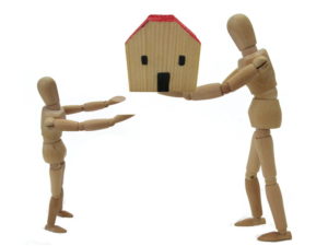 Adult handing house to a kid