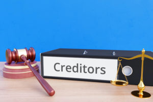 Creditors – Folder with labeling, gavel and libra – law, judgement, lawyer