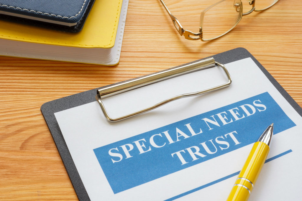 Special needs trust application with clipboard and notepad.