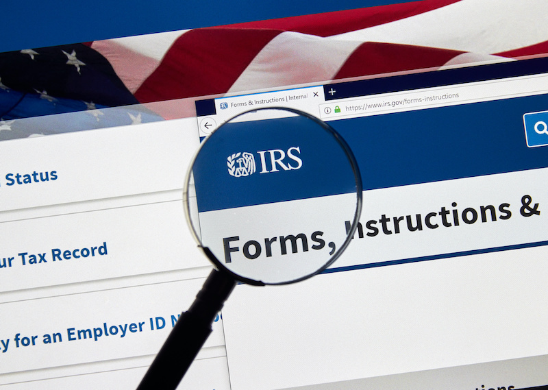 MONTREAL, CANADA - APRIL 24, 2019 : IRS Forms and Instructions USA Government home page under magnifying glass. IRS.com is an official web site of Internal Revenue Service