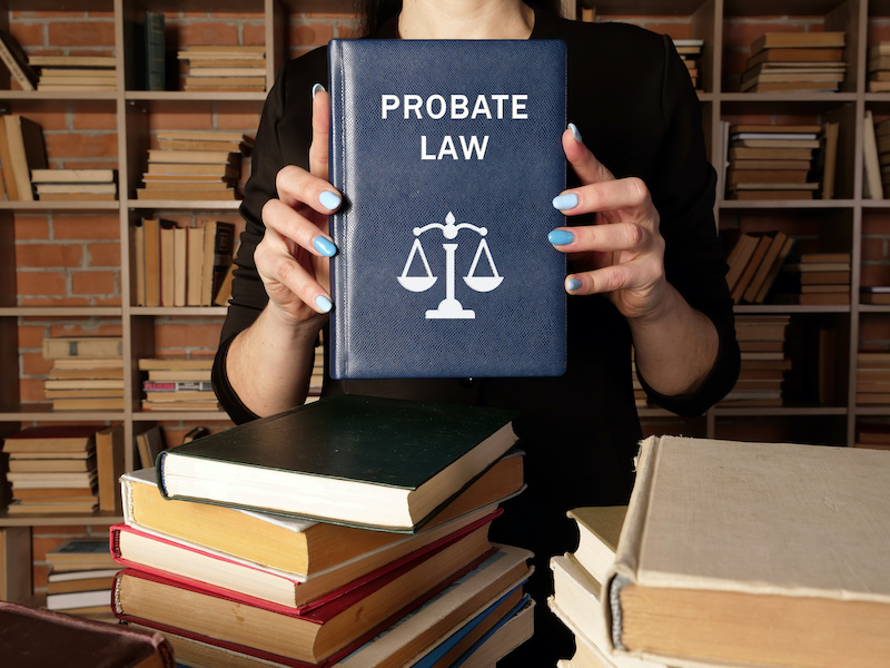 PROBATE LAW phrase on the book. Probate law refers to the process that manages any assets and debts left behind by a deceased person