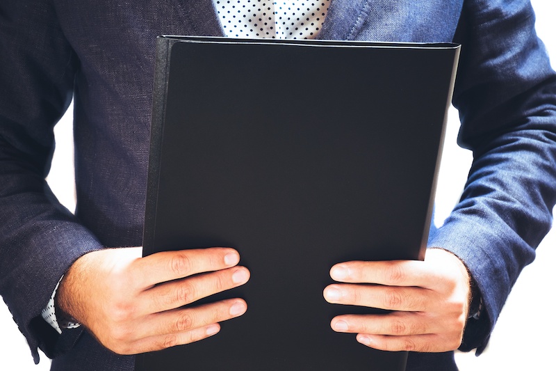 Lawyer reading legal contract agreement, person in elegant business suit examining document. On white isolated background.