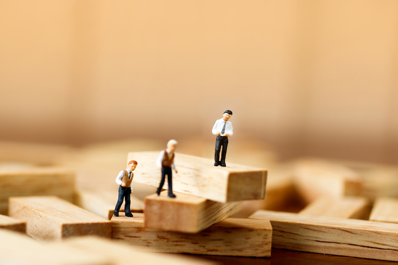 miniature people standing on wood block stack,  Business concept for growth success process.