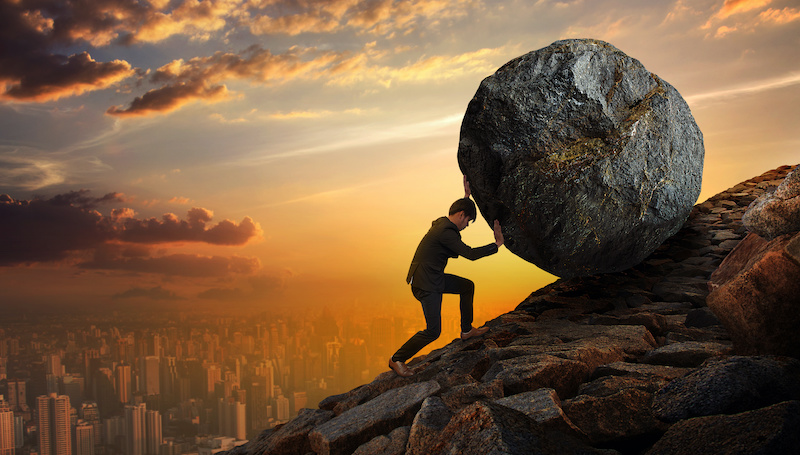 Business man pushing large stone up to hill , Business heavy tasks and problems concept.