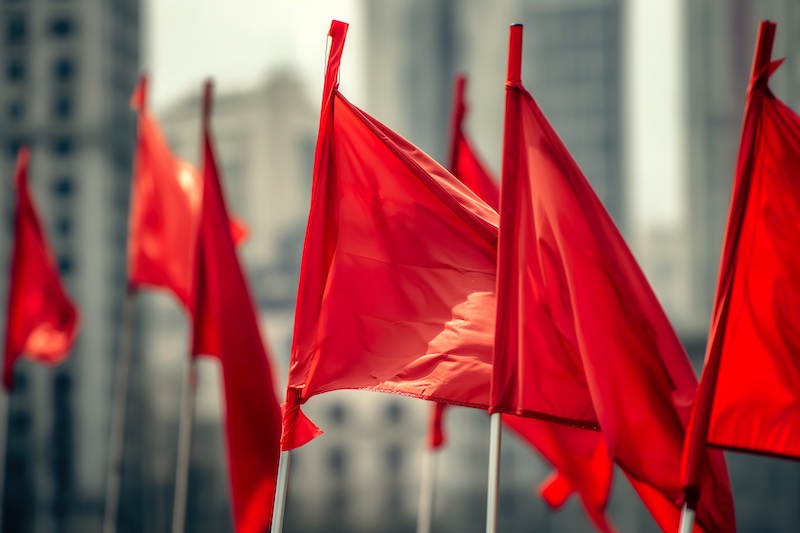 A vibrant group of red flags fluttering boldly in the wind.