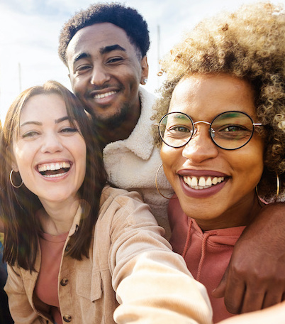 United group of happy young friends having fun while taking a selfie with mobile phone outdoors - Diverse group of millennial people laughing together during vacation - Friendship and holidays concept