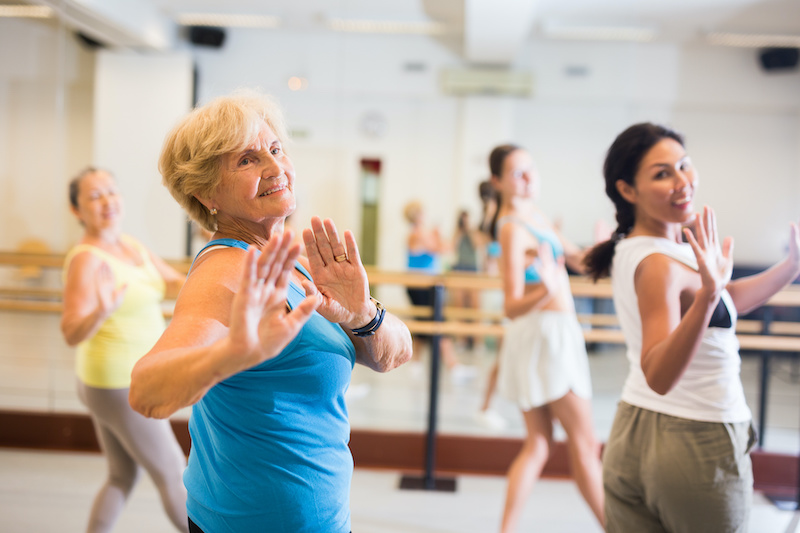 Women of different ages dancing together during their group training.