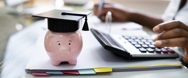 African American Women Accounting With Graduation Cap on piggy bank for inheritance for education