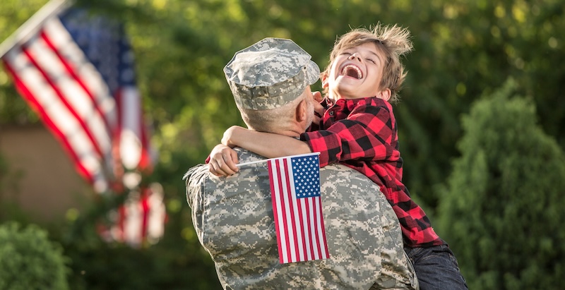 Happy reunion of soldier with family outdoors military family