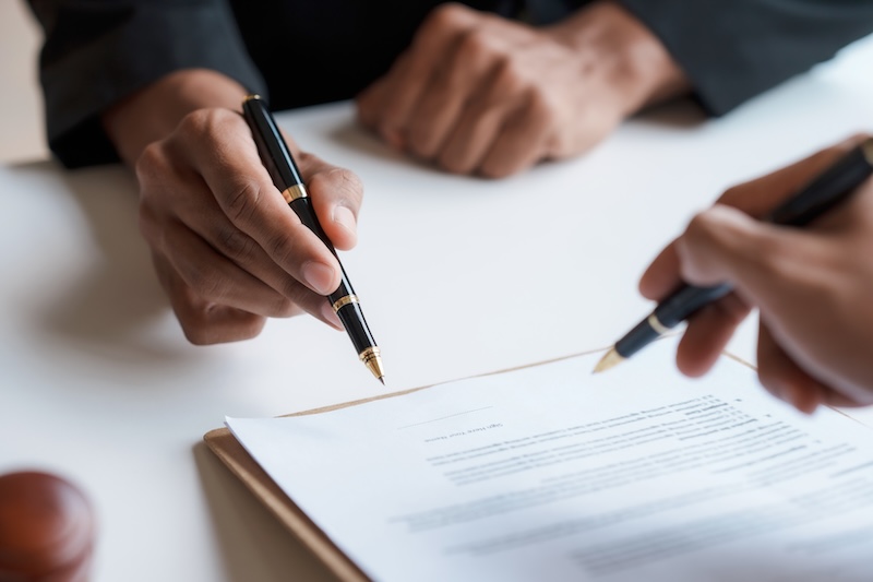 Lawyer and client sign variou financial legal contract to mediate with the legal execution department and make appointment for client to mediate debt settlement agreement.