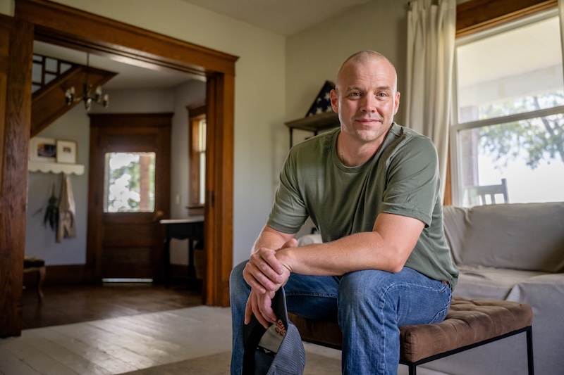 Marine veteran at home with family poses for portrait. veteran's estate