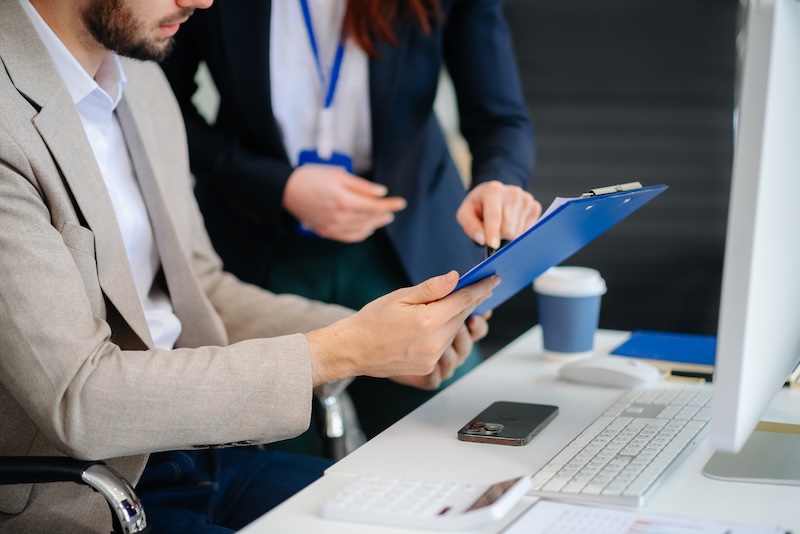 Businessman and team analyzing financial statement Finance task. with smart phone and laptop and  tablet. Wealth management concept