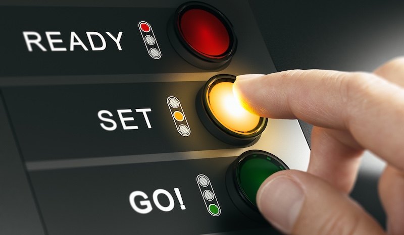 Man pressing countdown buttons on a board to start an event or a race. Composite image between a hand photography and a 3D background.