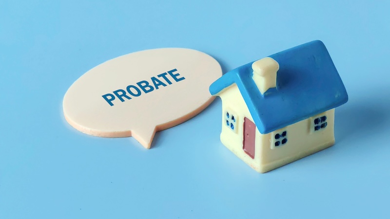 Miniature House Model and Speech Bubble with the Word 'PROBATE' Representing Legal Estate Planning and Property Inheritance