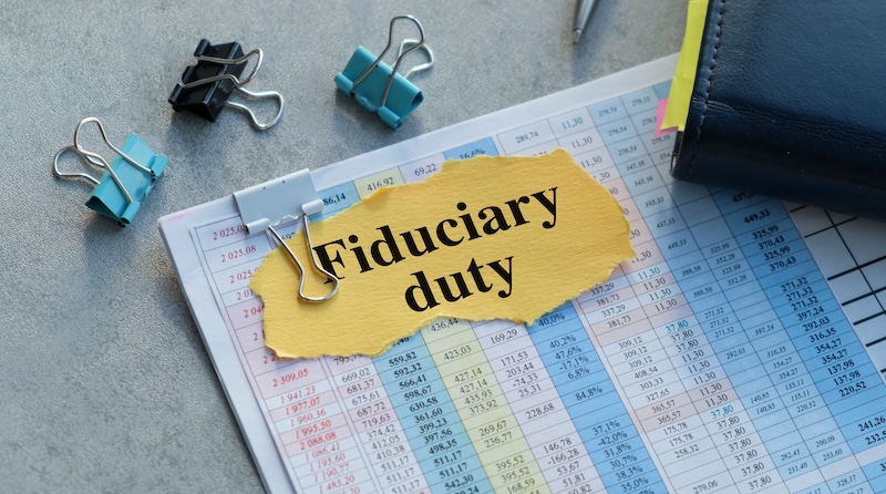 Fiduciary duty text on yellow paper on a gray background, Business Concept