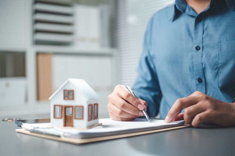 mortgage, calculator, loan, interest, rate, payment, A professional signing real estate documents beside a small house model, illustrating mortgage loan planning and property investment.