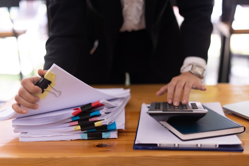 Close-up hand of Asian businesswoman arranging documents on her desk