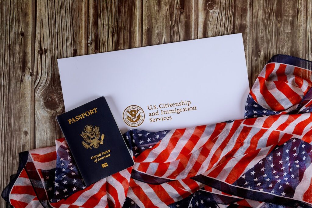 USA passport and citizenship naturalization certificate of US flag over wooden background SSUCv3H4sIAAAAAAAACnRRy07DMBC8I/EPkc+NZNeBEr6AGx9QcVg/aExdu7IdUFX131nHMfgAN+/MenZm93p/13VEQDSSPHfXXGFtrJ1jCpCMdwjTzYoH7ZQOLaKVST4YsC0oIMnJwUkj6GZrM3xbSBITpDnqmIetkISkD6hRwB+J4mhf6q4SC4k/kCIv3hoFl0g2DRdnkblX8aFliqQyZdY/QrX5D51fgfJ4qxnhoJ28LDGaeEFbDSXevrSS41fS4dQGhlkZ32T99BJsbuCN0jkYadyh+ebTtOy+fpN+dilkC6Q6J9b7MwibF/+OmrriE8SI7arizSCJl/anZo7zaQmwqhKF98kl41v2REfKH3Yjp2y7o2tDuelkUGexU4Wwlkej2ugmOyAcHiXbSdEzOdB+QMl+5GLogY4gOBvYSCku/vYNAAD//wMA/Hn5v50CAAA=