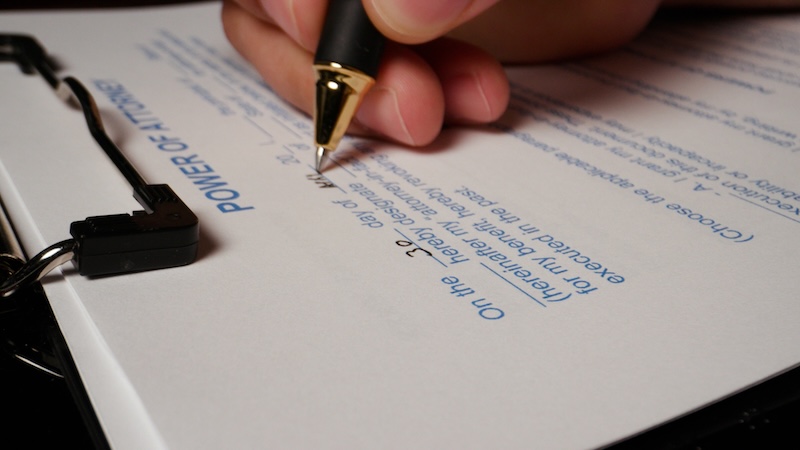 5 photo hispanic male hand filling out writing power of attorney form. High quality photo